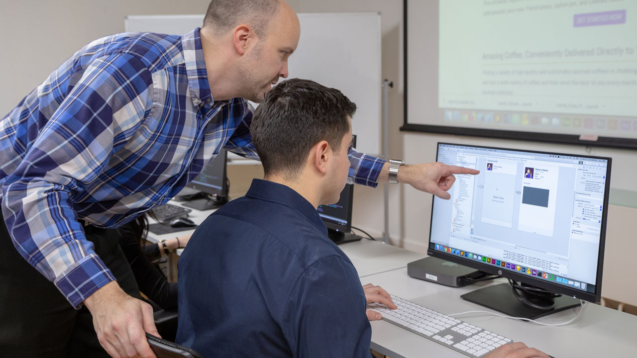 NextGen instructor helping a student